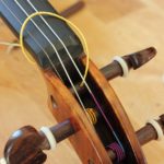 change violin strings by threading in the right end of the string into the peg