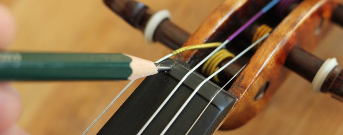 change violin strings and lubricate the string grooves